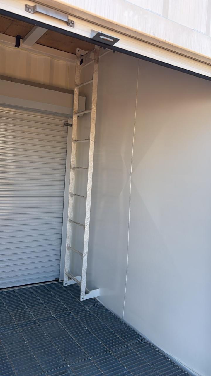 Internal top-access ladder and steel grating floor